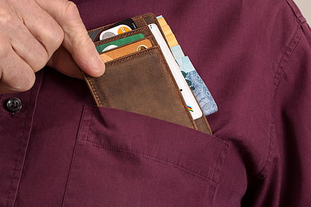 person holding brown wallet thumbnail