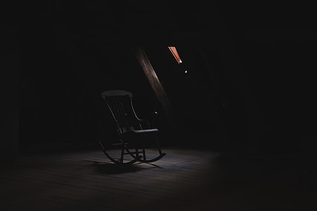 brown wooden rocking armchair near window panel thumbnail