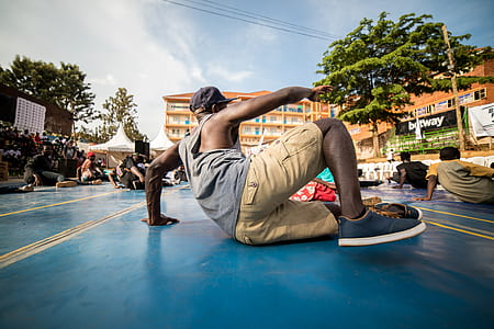 man sitting on blue concrete floor during daytime thumbnail