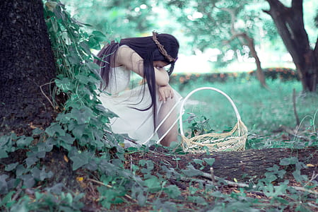 woman sitting near tree with basket thumbnail