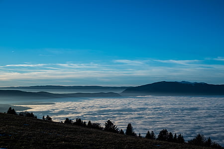 mountain viewing calm sea under blue skies thumbnail