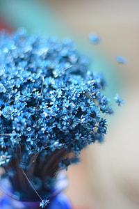 focus photo of blue petaled flowers bouquet with purple glass vase thumbnail