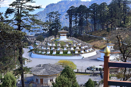 white-and-brown concrete temple near green leafed trees thumbnail