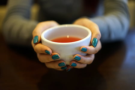 person with teal manicure holding white ceramic bowl thumbnail