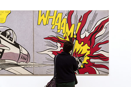 A person looks at pop art by Roy Lichtenstein in an art gallery in London, England thumbnail