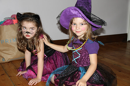 two girls in costume sitting on floor thumbnail