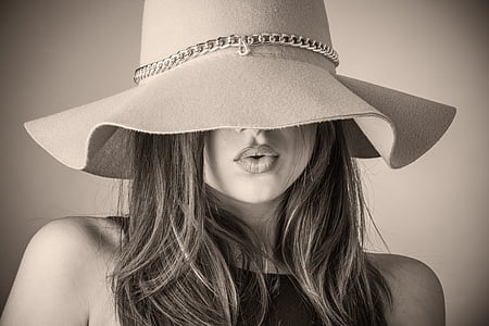 grayscale photo of woman wearing floppy hat and sleeveless shirt thumbnail