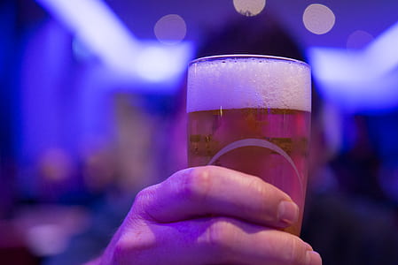 Person Holding Shot Glass Filled With Beer thumbnail