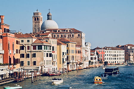assorted-type boats near building during daytime thumbnail