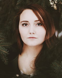 photo of woman near green pine tree leaves thumbnail