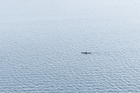 boat in the middle of body of water during daytime thumbnail