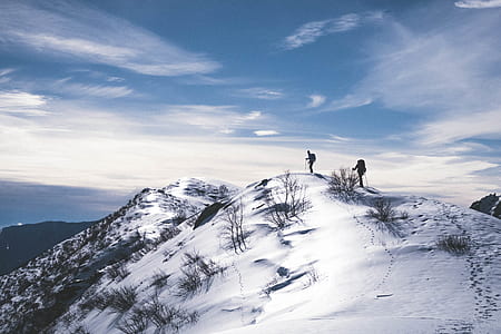 two person on top of mountain covered with snoe thumbnail