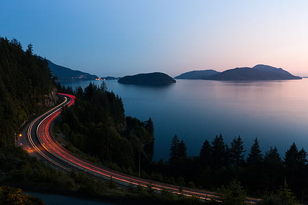 aerial photo of road near sea during nighttime thumbnail