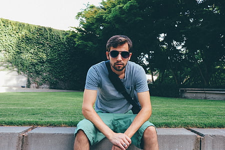 man sitting on concrete bench thumbnail