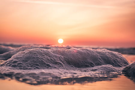 photo of bubbles under orange sky during golden hour thumbnail
