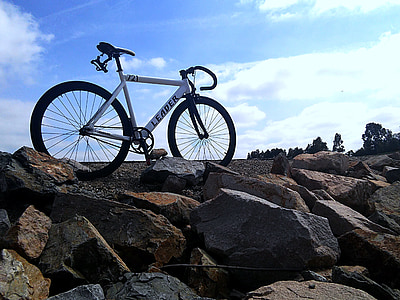 white and black Leader road bicycle parked on gray sand thumbnail