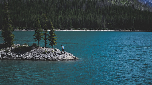 person near body of water near island thumbnail