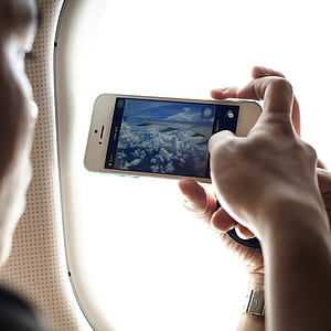 person using phone captured airplane wing thumbnail