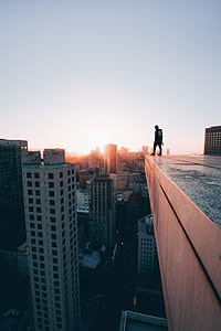 person standing on the rooftop of the building thumbnail
