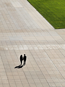 silhouette of man and woman holding hands while walking thumbnail