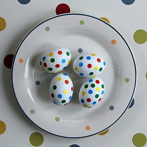 four multicolored Easter Eggs on plate thumbnail