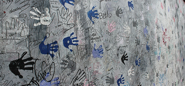 gray concrete panel with assorted-color hand prints thumbnail