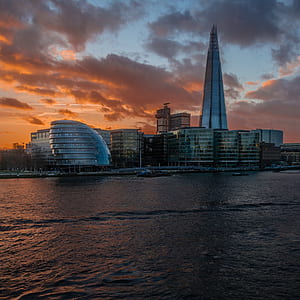 cityscape near body of water at sunset thumbnail