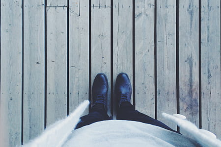 person wearing black wing tip dress shoes thumbnail