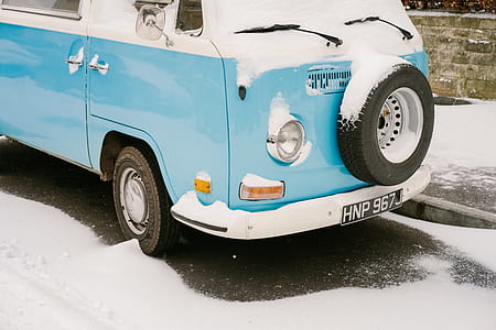 teal and white Volkswagen Type 2 T2 parked on road thumbnail