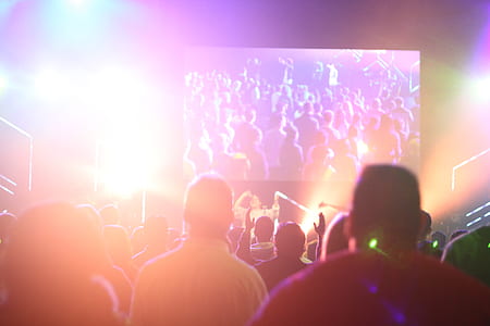 people gathering in event looking at group people performing on stage thumbnail