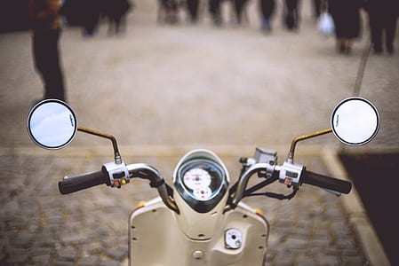 selective focus photo of beige motor scooter on road thumbnail