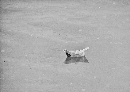 photo of paper boat floating on calm water thumbnail