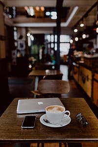 Cup of coffee on table in cafe thumbnail