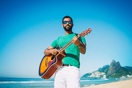 man playing acoustic guitar outdoor thumbnail