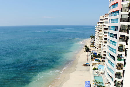 white buildings beside beach during daytime thumbnail