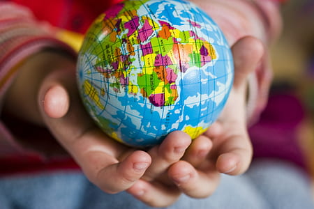 person holding blue terrestrial globe thumbnail