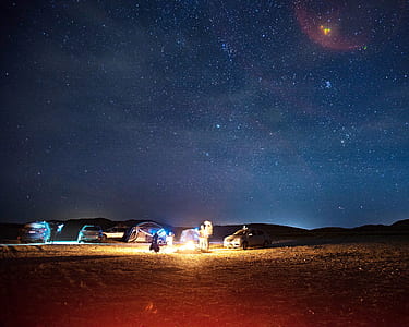 people camping on desert at nighttime thumbnail