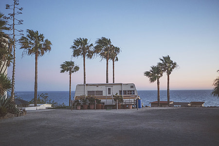 gray camper trailer near the ocean thumbnail