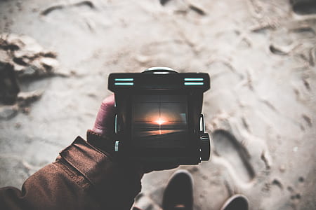 person holding black lamp thumbnail