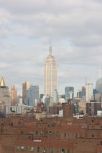 Empire State Building in midtown Manhattan surrounded with other skyscrapers thumbnail
