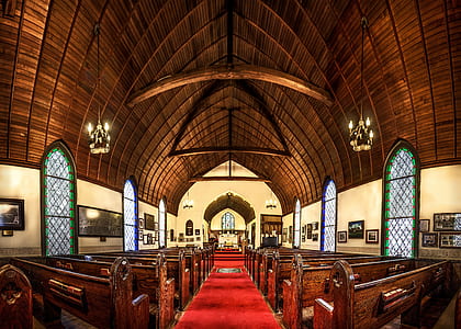 brown wooden pews in church thumbnail