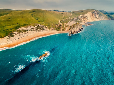 bird's-eye photography of sea and mountain thumbnail