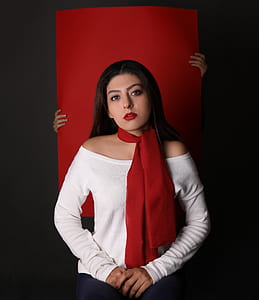 woman in white off-shoulder shirt in front of red textile thumbnail