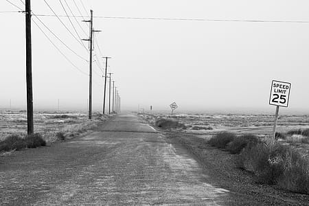 Monochrome Photography of an Empty Road With Speed Limit Sign thumbnail