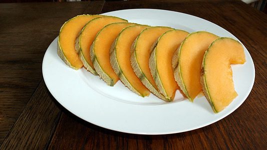 sliced melons on white plate thumbnail