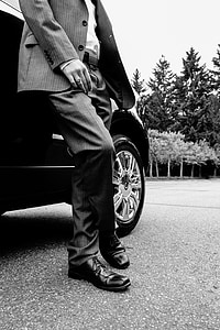 man standing beside car thumbnail