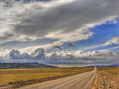 gray asphalt road under blue and white cloudy sky thumbnail