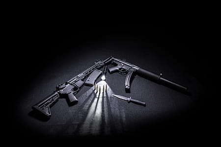 Two Black Assault Rifles Besides Tactical Knife, Bullets, and Torch. thumbnail