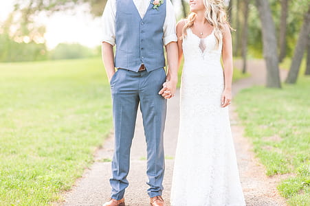 man and woman holding hands on pathway thumbnail