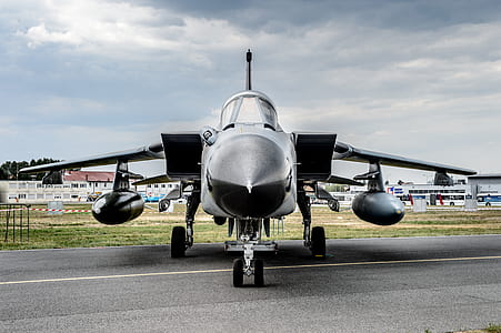 black fighter jet on road thumbnail